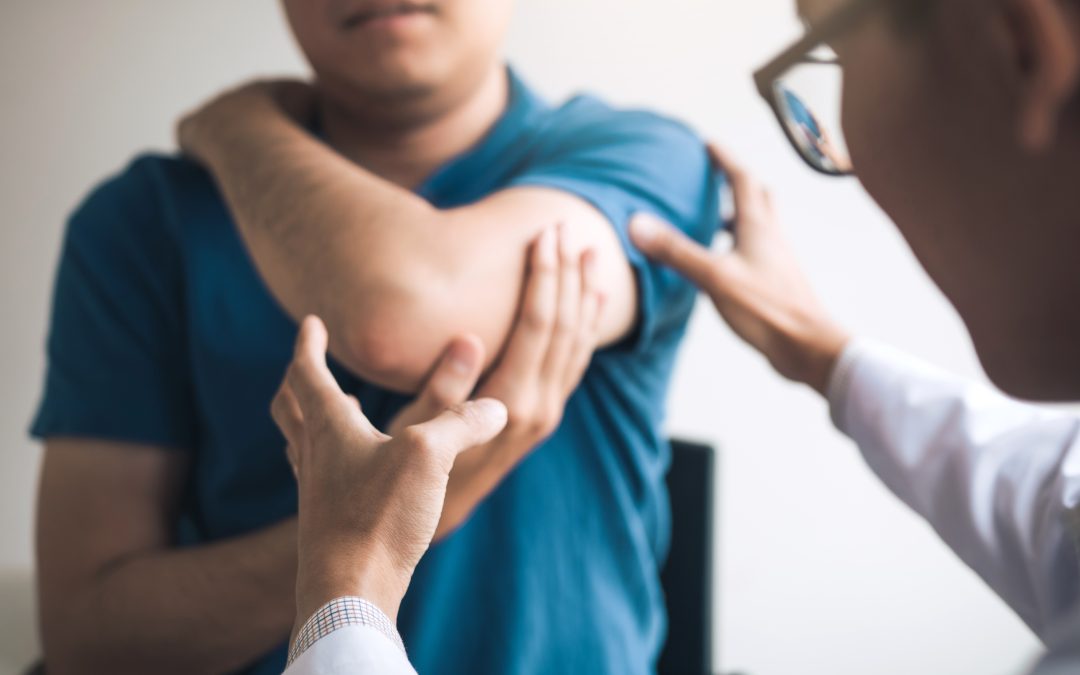 Physical Therapists Are Checking Patients Elbows At The Clinic Office Room.